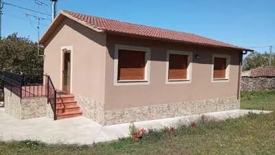 a small house with a staircase in front of it at Casa do Carpinteiro in Brocos