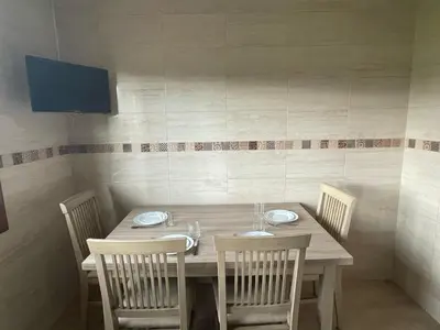 a dining room table with chairs and a wooden table and chairsktop at Casa do Carpinteiro in Brocos