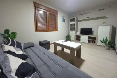 a living room with a couch and a table at Casa do Carpinteiro in Brocos
