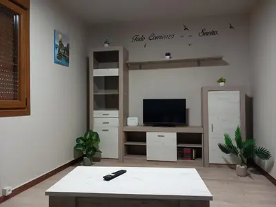 a living room with a tv and a coffee table at Casa do Carpinteiro in Brocos