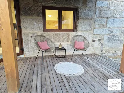 two chairs with pink pillows sitting on a deck at Palleira da Aira in Entrambosríos
