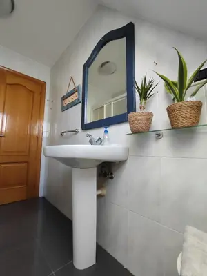 a bathroom with a sink and a mirror on the wall at Apartamento centro de Sada in Sada