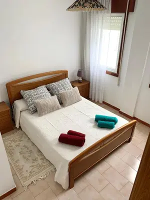 a bedroom with a bed with two pillows on it at Apartamento Playa de Foz in Foz
