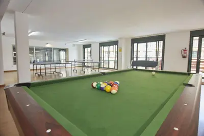 a pool table with balls on it in a room at Spa Costa Reinante in San Miguel de Reinante