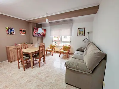 a living room with a couch and a table at Apartamento Rosalía de Castro Ribadeo in Ribadeo