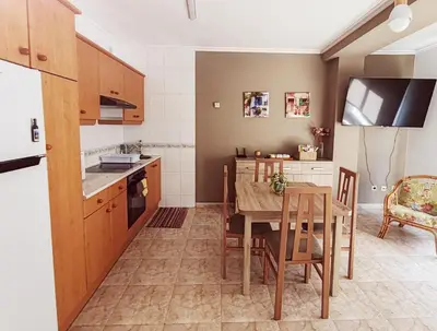 a kitchen and dining room with a table and chairs at Apartamento Rosalía de Castro Ribadeo in Ribadeo