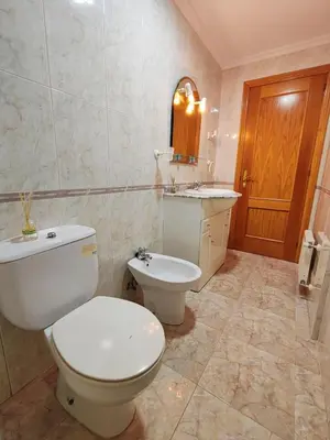 a bathroom with a toilet and a sink at Apartamento Rosalía de Castro Ribadeo in Ribadeo