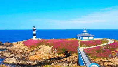 two lighthouses on an island in the ocean at Apartamento Rosalía de Castro Ribadeo in Ribadeo