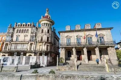 an old building with a tower on top of it at Apartamento Rosalía de Castro Ribadeo in Ribadeo