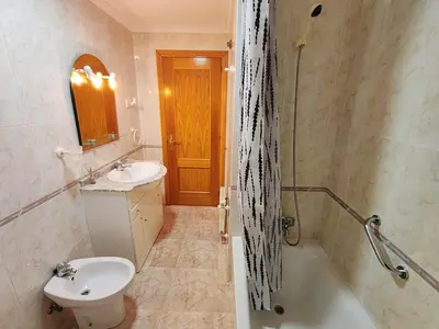 a bathroom with a sink and a toilet and a tub at Apartamento Rosalía de Castro Ribadeo in Ribadeo