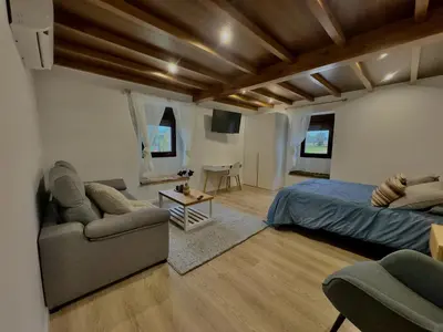 a bedroom with a bed and a couch and a table at a revolta Boqueixon in Lestedo