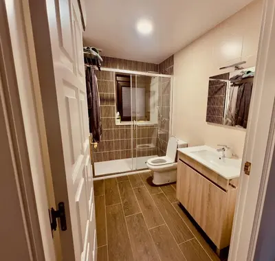 a bathroom with a toilet and a sink and a shower at a revolta Boqueixon in Lestedo