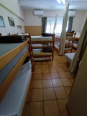 a room with a group of bunk beds in a room at Albergue Ultreia Sigueiro in Sigüeiro