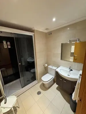 a bathroom with a toilet and a sink and a shower at Apartamento Rammari Spa in San Miguel de Reinante