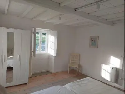 a white room with a bed and a window at Casa Castro in Lamas