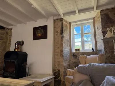 a living room with a stove and a couch at Casa Castro in Lamas