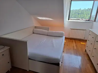 a bed in a room with a large window at A&M Real Estate in Milladoiro