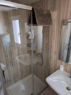a bathroom with a shower and a sink at A&M Real Estate in Milladoiro