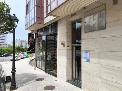 a store front of a building on a city street at A&M Real Estate in Milladoiro