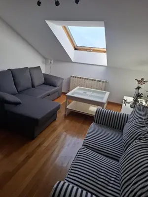a living room with a couch and a table at A&M Real Estate in Milladoiro