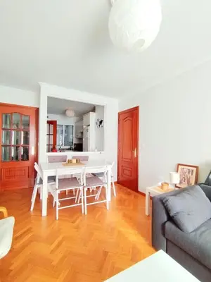 a living room with a table and a couch at Con Encanto en la Playa in Viveiro