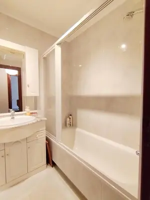 a white bathroom with a tub and a sink at Con Encanto en la Playa in Viveiro