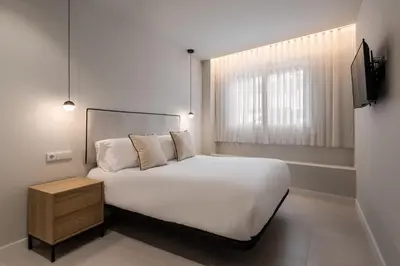 a bedroom with a white bed and a window at Loft América 41 A in Melide