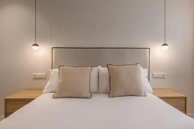 a bedroom with a white bed with two pillows at Loft América 41 A in Melide