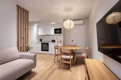 a living room and kitchen with a table and a couch at Loft América 41 A in Melide
