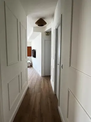 an empty hallway with white walls and wooden floors at Las Cuatro Calles in Ribadeo