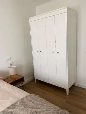a white cabinet in a bedroom with a bed at Las Cuatro Calles in Ribadeo