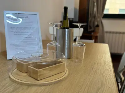 a table with two glasses and a bottle of wine at Rei Túzaro in Milladoiro