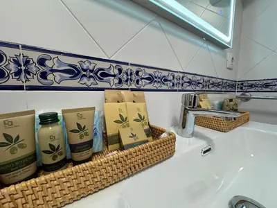a bathroom sink with a rack of soap and candles at Rei Túzaro in Milladoiro