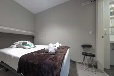 a bedroom with a bed with towels on it at Kumano Kodo by Como en Casa in Santiago de Compostela