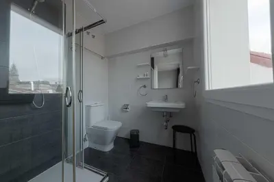 a bathroom with a toilet and a sink and a shower at Kumano Kodo by Como en Casa in Santiago de Compostela