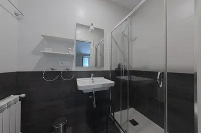 a bathroom with a sink and a glass shower at Kumano Kodo by Como en Casa in Santiago de Compostela