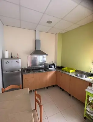 a kitchen with a refrigerator and a microwave at Precioso apartamento a 1 minuto de la playa in Foz