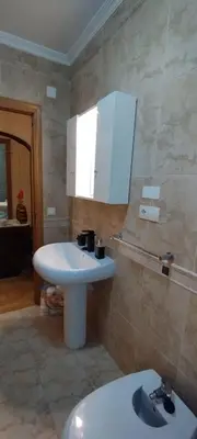 a bathroom with a white sink and a toilet at Apartamento Los Gallegos in Foz