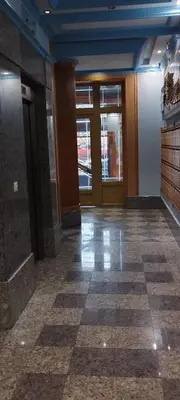 an empty lobby with doors and a tile floor at Apartamento Los Gallegos in Foz