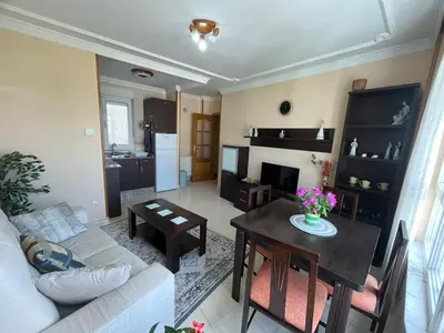 a living room with a couch and a table at Apartamento Los Gallegos in Foz