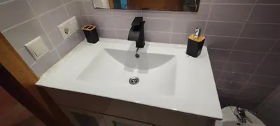 a white sink in a bathroom next to a toilet at Piso Altos de Foz in Foz