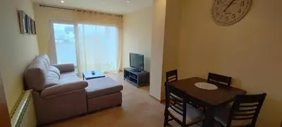 a living room with a couch and a table at Piso Altos de Foz in Foz