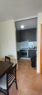 a kitchen with a dining table and a kitchen with a stove at Piso Altos de Foz in Foz