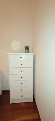 a white dresser with a plant on top of it at Amma Ribeira Sacra in Monforte de Lemos