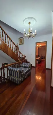 a living room with a chandelier and a couch at Amma Ribeira Sacra in Monforte de Lemos