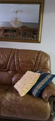 a pillow sitting on a couch under a mirror at Amma Ribeira Sacra in Monforte de Lemos