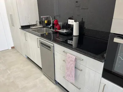 a kitchen with a sink and a stove top oven at Vistas del Parque in Santiago de Compostela