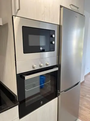 a stainless steel oven with a microwave in a kitchen at Vistas del Parque in Santiago de Compostela