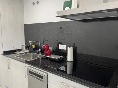 a kitchen with a sink and a counter top at Vistas del Parque in Santiago de Compostela