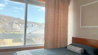 a bedroom with a bed and a large window at Casa Pazos, Pedrafita do Cebreiro in Piedrafita